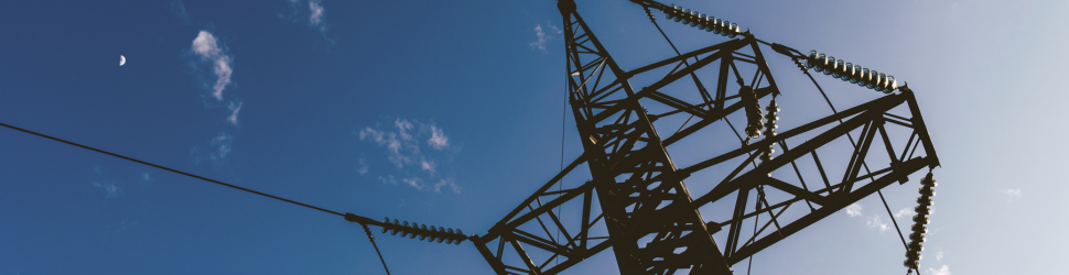 High-voltage electricity transmission infrastructure representing Regulatory Intelligence for utility capital planning